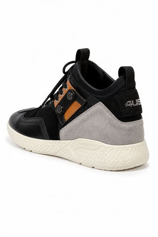 Cesare Paciotti luxury Italian men's sneakers in black suede and leather with silver hardware, side view showing durable rubber sole.