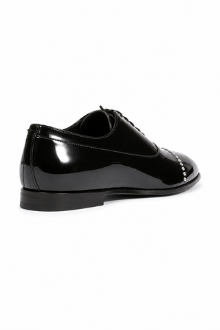 Cesare Paciotti black patent leather oxford shoes with silver stud detailing and a sleek formal design.