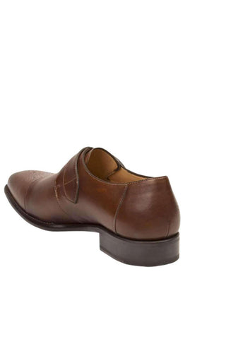 Cognac calf-skin leather Mezlan single monk-strap shoe with a classic medallion cap toe and buckle closure.