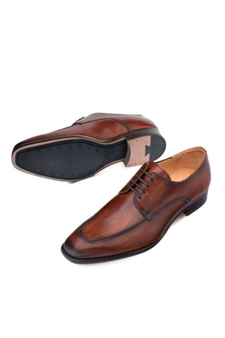 Cognac Mezlan Coventry leather derby with apron split toe and durable rubber-inlaid sole.
