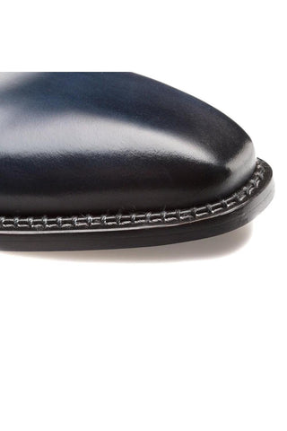 Close-up of a blue Mezlan Enterprise whole-cut Oxford showing smooth calfskin leather and detailed contrast welt stitching.