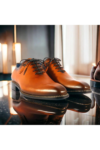 Cognac calfskin leather whole-cut Oxfords with a sleek plain toe and contrast stitching on an extended welt.