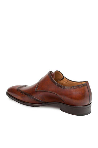 Cognac hand-burnished calf-skin leather wing-tip single monk-strap shoe with refined perforations and a durable sole.