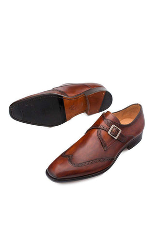 Cognac hand-burnished calf-skin leather wing-tip single monk-strap shoes with a durable rubber and leather sole.