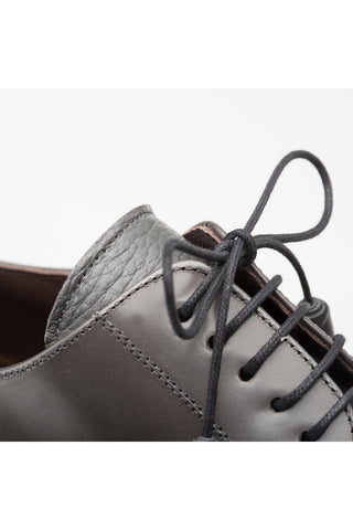 Close-up of Mezlan Soka gray derby shoe featuring premium calf and deer-skin leather with black laces.